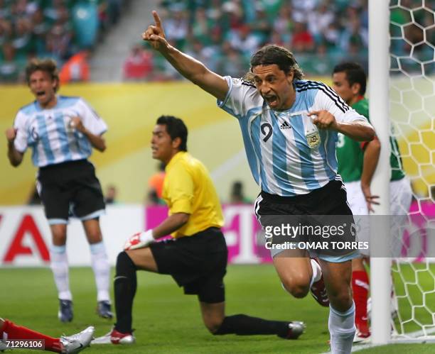 Argentinian forward Hernan Crespo celebrates next to Mexican goalkeeper Oswaldo Sanchez after Mexican forward Jared Borgetti scored an own goal...