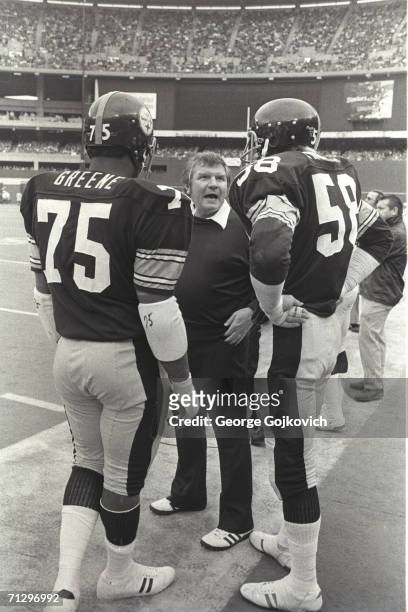 Defensive line coach George Perles, center, of the Pittsburgh Steelers talks with defensive lineman Joe Greene and linebacker Jack Lambert during a...