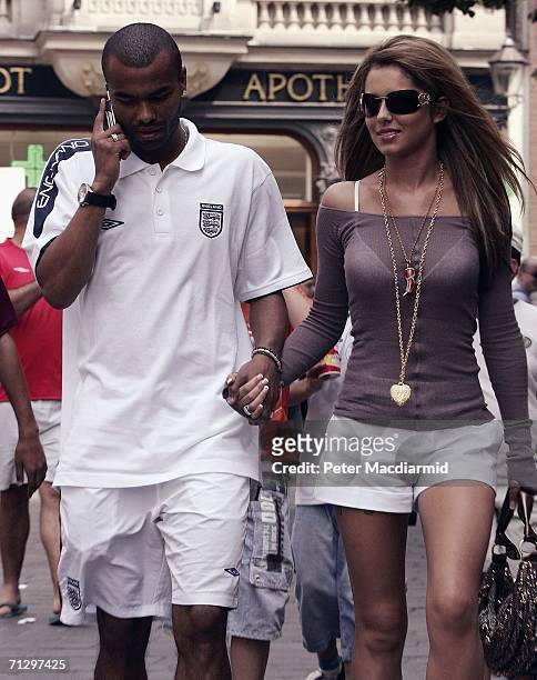 England footballer Ashley Cole and his partner singer Cheryl Tweedy of Girls Aloud walk to the shops on June 26, 2006 in Baden-Baden, Germany....