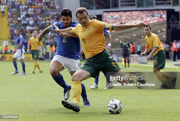 Mark Viduka of Australia crosses the ball as Gennaro Gattuso of Italy closes in during the FIFA World Cup Germany 2006 Round of 16 match between...