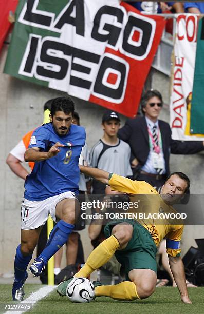 Kaiserslautern, GERMANY: Australian forward Mark Viduka challenges Italian midfielder Gennaro Gattuso during the round of 16 World Cup football match...