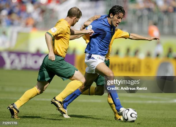 Luca Toni of Italy is challenged by Scott Chipperfield of Australia during the FIFA World Cup Germany 2006 Round of 16 match between Italy and...