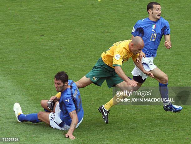 Kaiserslautern, GERMANY: Italian defender Marco Materazzi tackles Australian midfielder Marco Bresciano during the round of 16 World Cup football...