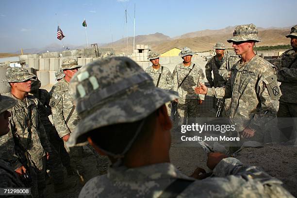 American soldiers from the 2nd Battalion, 4th Infantry Regiment are briefed ahead of a mission from their base June 26, 2006 at Deh Afghan in the...