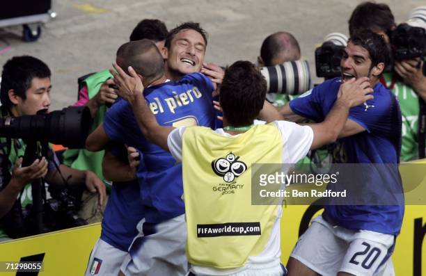 Francesco Totti of Italy is congratulated by teammates, after scoring the match winning penalty during the FIFA World Cup Germany 2006 Round of 16...