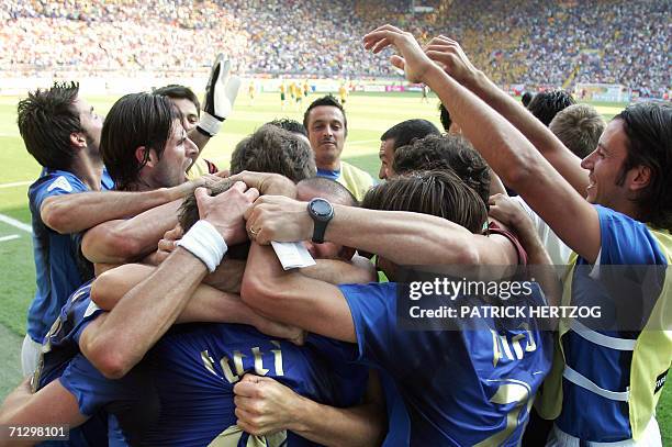 Kaiserslautern, GERMANY: Teammates crowd around Italian midfielder Francesco Totti after he scored on a penalty kick for the game winning goal at the...