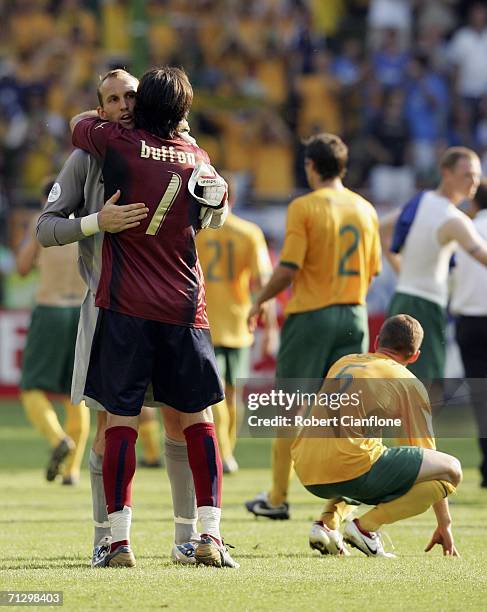 Goalkeeper Mark Schwarzer of Australia is consoled by his opposite number, Gianluigi Buffon of Italy, following his team's 1-0 defeat and ext from...