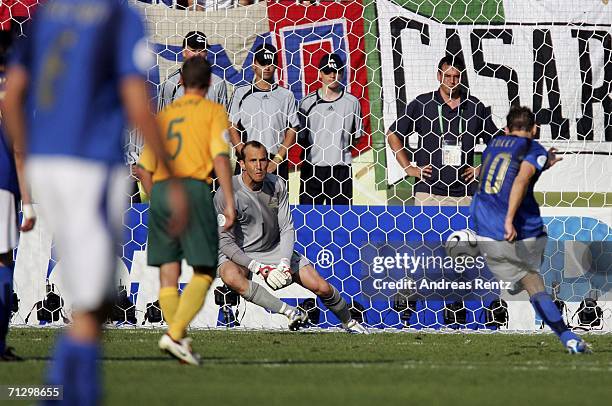 Francesco Totti of Italy scores the match winning penalty, past Goalkeeper Mark Schwarzer of Australia during the FIFA World Cup Germany 2006 Round...