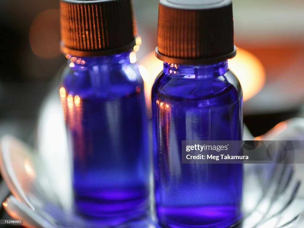 Close-up of two aromatherapy oil bottles