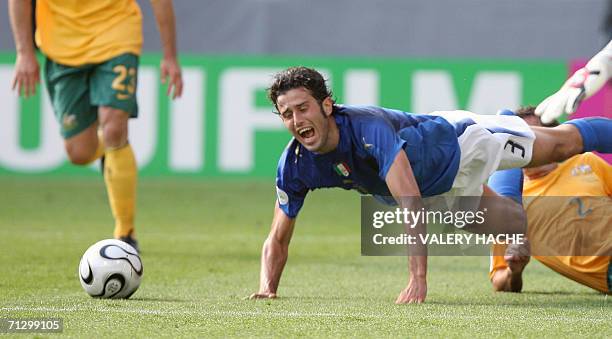 Kaiserslautern, GERMANY: Australian defender Lucas Neill brings down Italian defender Fabio Grosso that resulted in a penalty kick for Italy at the...