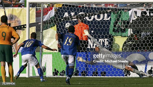 Goalkeeper Mark Schwarzer of Australia, dives in vain as the match winning penalty from Francesco Totti of Italy, flies into the net during the FIFA...