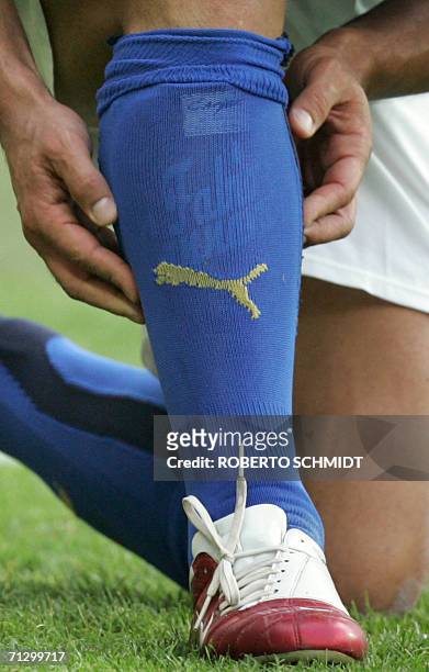Kaiserslautern, GERMANY: Italian defender Fabio Grosso pulls up his sock during the round of 16 World Cup football match between Italy and Australia...