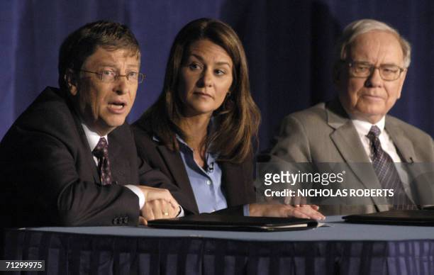 New York, UNITED STATES: Microsoft co-founder and chairman Bill Gates answers questions during a news conference 26 June 2006 in New York with wife...