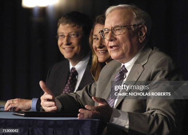 New York, UNITED STATES: Microsoft co-founder and chairman Bill Gates and his Melinda Gates listen as US investment guru Warren Buffett addresses a...