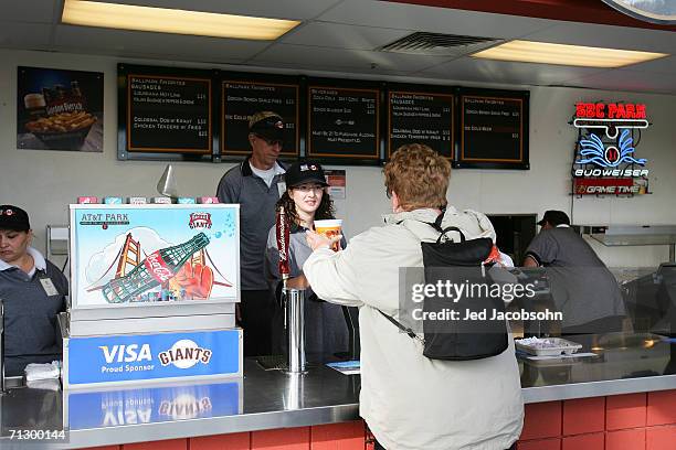 An employeee of the Dirby Grill serves beer before the San Francisco Giants play against the Los Angeles Dodgers during the MLB game at AT&T Park on...