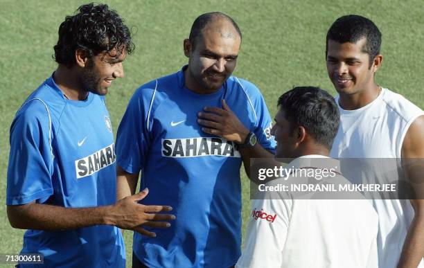 Indian cricketers Munaf Patel , Virender Sehwag and S. Sreesanth joke with West Indian cricketer Daren Ganga at the end of play on the fifth and...