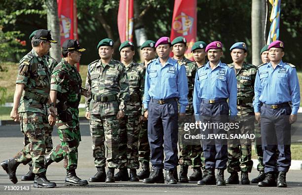 Indonesian military chief Djoko Suyanto and his Malaysian counterpart Muhammad Anwar bin Muhammad Nur inspect their troops during a ceremony in...