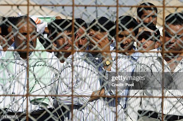 Detainees stand in the Abu Ghraib prison yard while waiting to be released on June 27, 2006 in Baghdad, Iraq. Another 500 detainees were released...