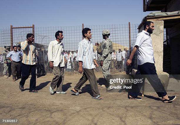Detainees leave Abu Ghraib prison after waiting to be released on June 27, 2006 in Baghdad, Iraq. Another 500 detainees were released from Abu Ghraib...