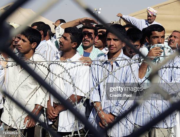 Detainees stand in the Abu Ghraib prison yard while waiting to be released on June 27, 2006 in Baghdad, Iraq. Another 500 detainees were released...