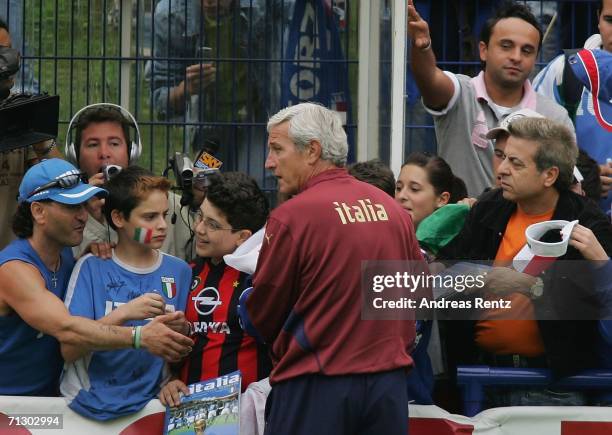 Coach Marcello Lippi signs autographs during an Italy National Football Team training on June 27, 2006 in Duisburg, Germany.