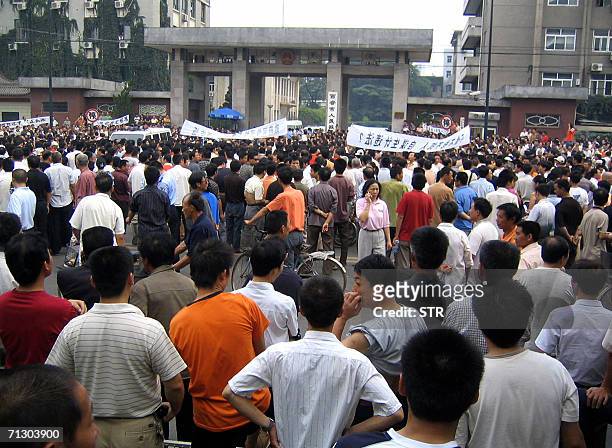 Thousands of protesters gather outside the Xian municipal government office in Xian, northern China's Shaanxi province, 27 June 2006, after...