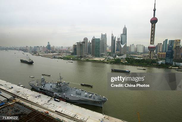 The flagship of the U.S. Navy's Pacific fleet, the USS Blue Ridge, docks near the landmark Oriental Pearl TV Tower at a port on June 27, 2006 in...