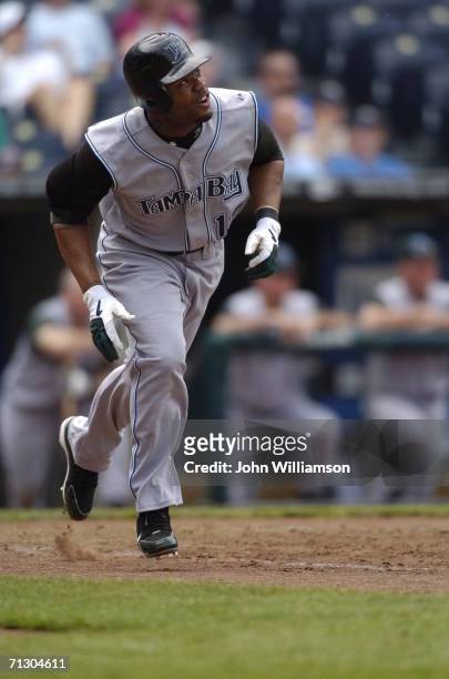 Left fielder Carl Crawford of the Tampa Bay Devil Rays runs to first base after hitting the ball during the game against the Kansas City Royals at...