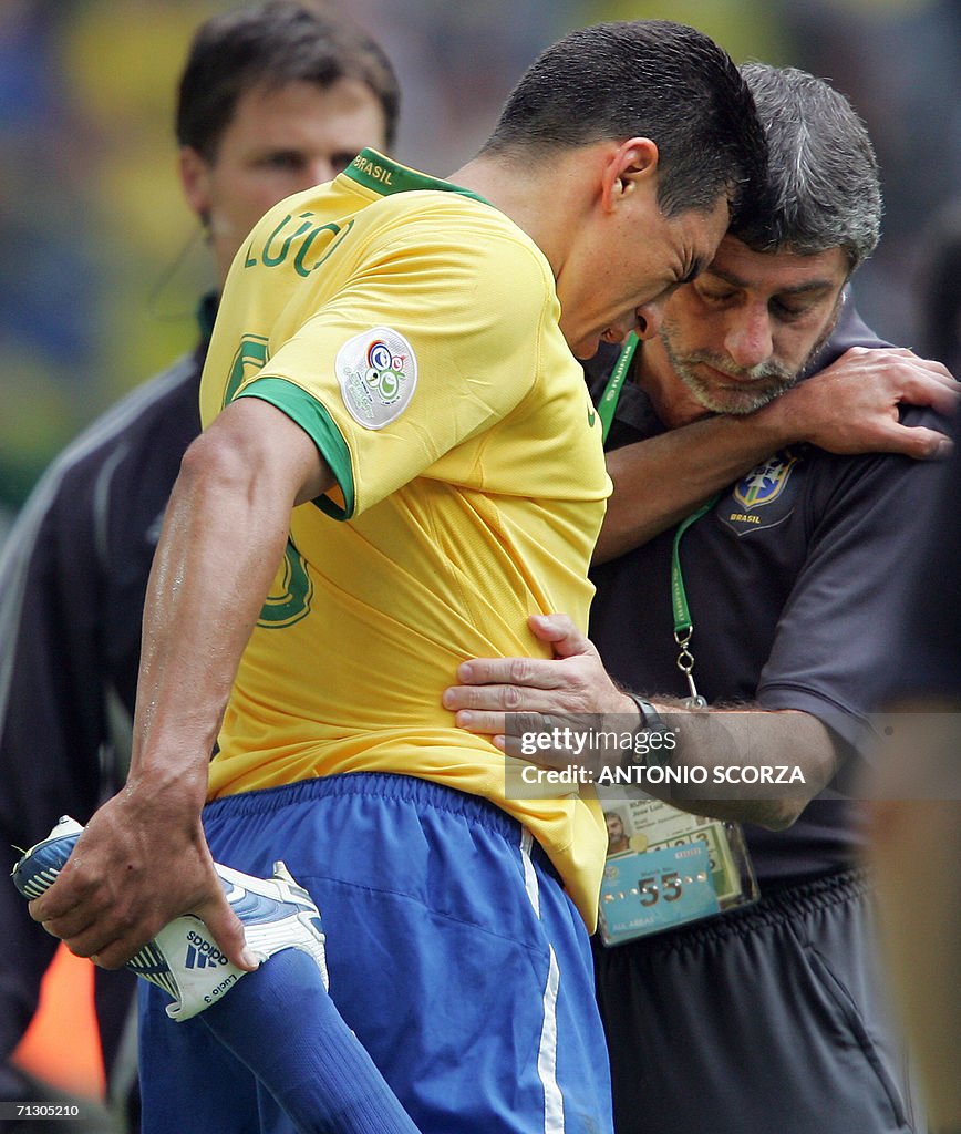 Brazilian defender Lucio (C) is helped b