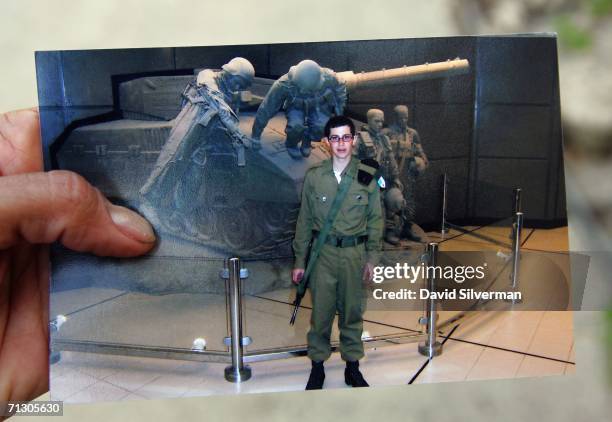 Elana Levi-Zrihan, a friend and neighbour of kidnapped Israeli soldier Gilad Shalit and his family, shows a photo of the young conscript visiting an...