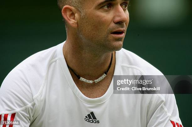 Andre Agassi of the United States wears a necklace showing 'Daddy Rocks' as he prepares to serve against Boris Pashanski of Serbia and Montenegro...