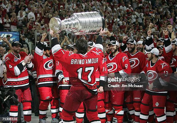 Rod Brind'Amour of the Carolina Hurricanes hoists the Stanley Cup in front of his teammates after the Hurricanes defeated the Edmonton Oilers in game...