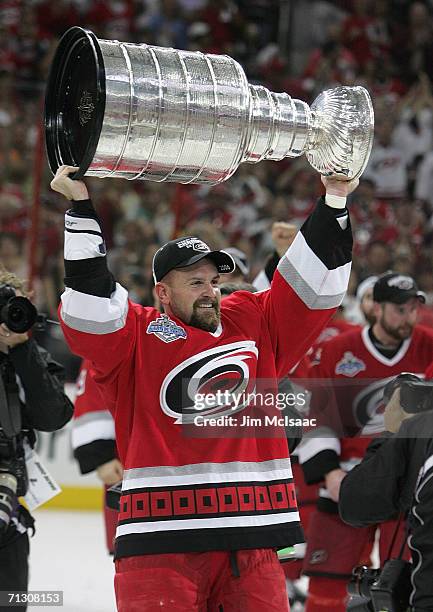 Cory Stillman of the Carolina Hurricanes hoists the Stanley Cup after the Hurricanes defeated the Edmonton Oilers in game seven of the 2006 NHL...