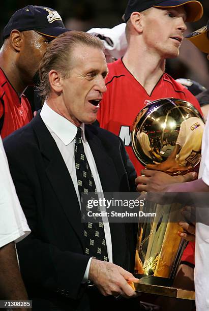 Head coach Pat Riley of the Miami Heat is handed the trophy after game six of the 2006 NBA Finals on June 20, 2006 at American Airlines Center in...