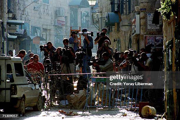 Photographers, cameramen and journalists from all over the world cover an operation of the Israeli army May 6, 2002 in Bethlehem, West Bank....