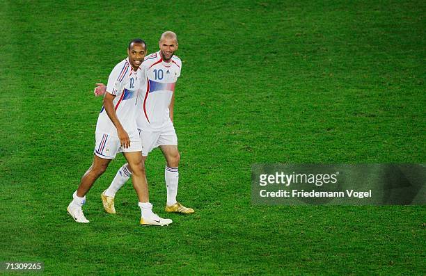 Zinedine Zidane of France celebrates victory with team mate Thierry Henry at the end of the FIFA World Cup Germany 2006 Round of 16 match between...