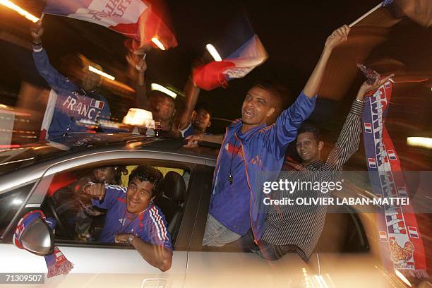 French football fans celebrate on the Champs-Elysees avenue in Paris at the end of the World Cup 2006 football match Spain vs France at Hanover...