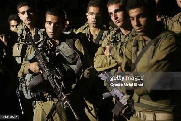 Israeli soldiers listen to a briefing just before they enter the Gaza Strip June 27, 2006 at the border at Kerem Shalom, Israel. Israeli Prime...