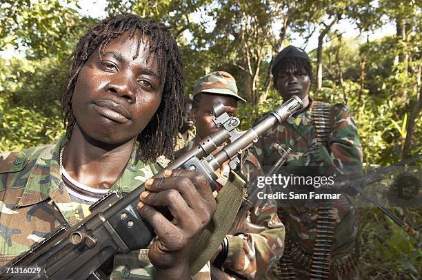 Soldier of the Ugandan rebel group, the Lord's Resistance Army, pose with their weapons during a rare appearance in front of journalists in this...