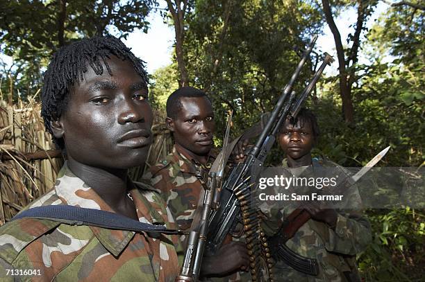 Soldier of the Ugandan rebel group, the Lord's Resistance Army, pose with their weapons during a rare appearance in front of journalists in this...