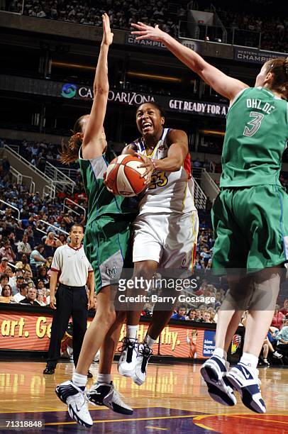 Cappie Pondexter of the Phoenix Mercury shoots against Nicole Ohlde of the Minnesota Lynx in a WNBA game played on June 28 at U.S. Airways Center in...