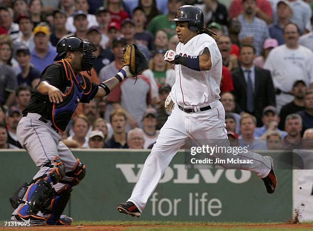 Manny Ramirez of the Boston Red Sox scores a run in the third inning past catcher Ramon Castro of the New York Mets on June 28, 2006 at Fenway Park...