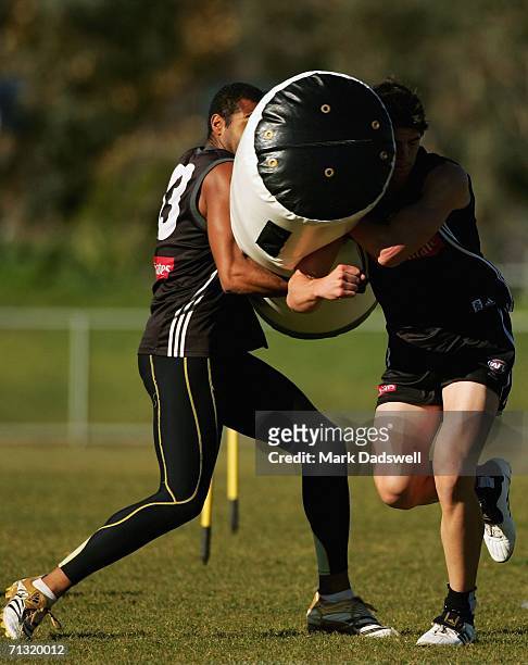 Harry O'Brien of the Magpies swings a tackle bag into Scott Pendlebury during the Collingwood training session June 29, 2006 in Melbourne, Australia.