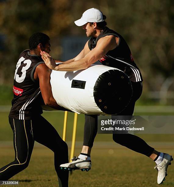 Harry O'Brien of the Magpies swings the tackle bag into Ryan Lonie during the Collingwood training session June 29, 2006 in Melbourne, Australia.