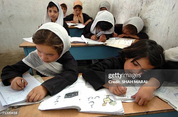 Afghan children attend a class during the distribution of school-bags by soldiers of the International Security Assistance Force in the Bagrami...