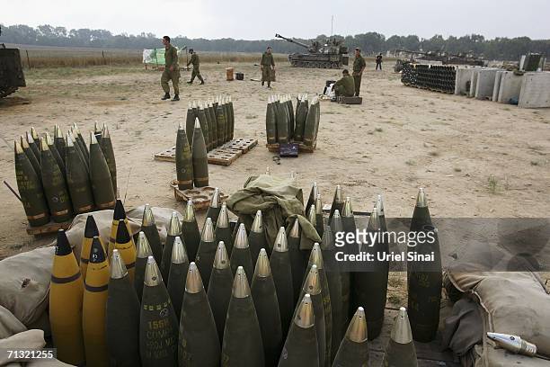 Israeli artillery shells sit beside mobile artillery firing units as soldeirs wait for orders to resume shelling the Gaza Strip from the Israeli...