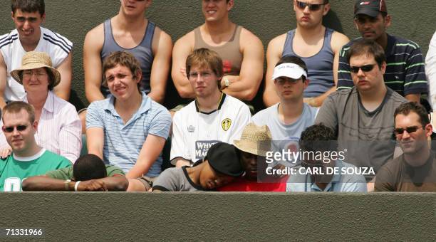 United Kingdom: Fans sleep in the stands as Maria Sharapova of Russia plays against US Ashley Harkleroad on the 2nd round of the Wimbledon Tennis...