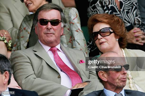 Sir Terry Wogan and his wife Helen sit behind HRH Prince Edward, Duke of Kent watching the action on Centre Court during day four of the Wimbledon...