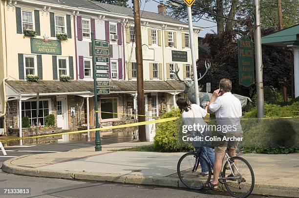 Onlookers watch as floodwaters from the Delaware River reach antique stores and businesses along Lambert Lane June 29, 2006 in Lambertville, New...