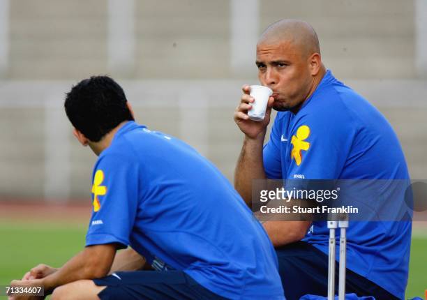 Ronaldo of Brazil has a drink during the Brazil National Football Team training session for the FIFA World Cup Germany 2006 at the Paffrather Street...